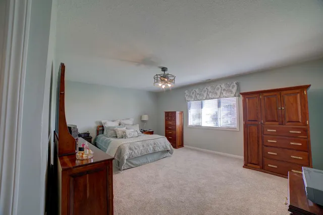 a living room with lots of furniture and a wooden floor