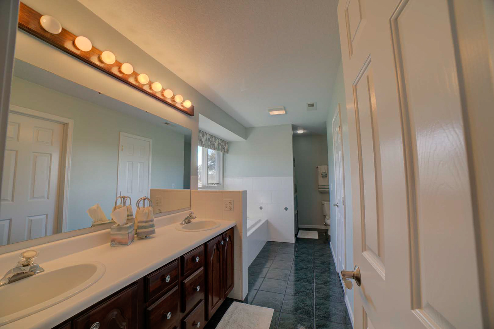 23 2130 East Watseka, IL 60970 - Photo 23 of 41 a bathroom with a double vanity sink and a mirror