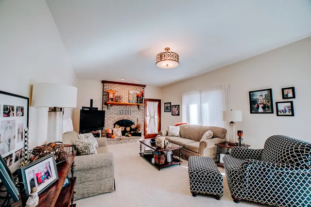 a bedroom with a bed and a chair with the walls