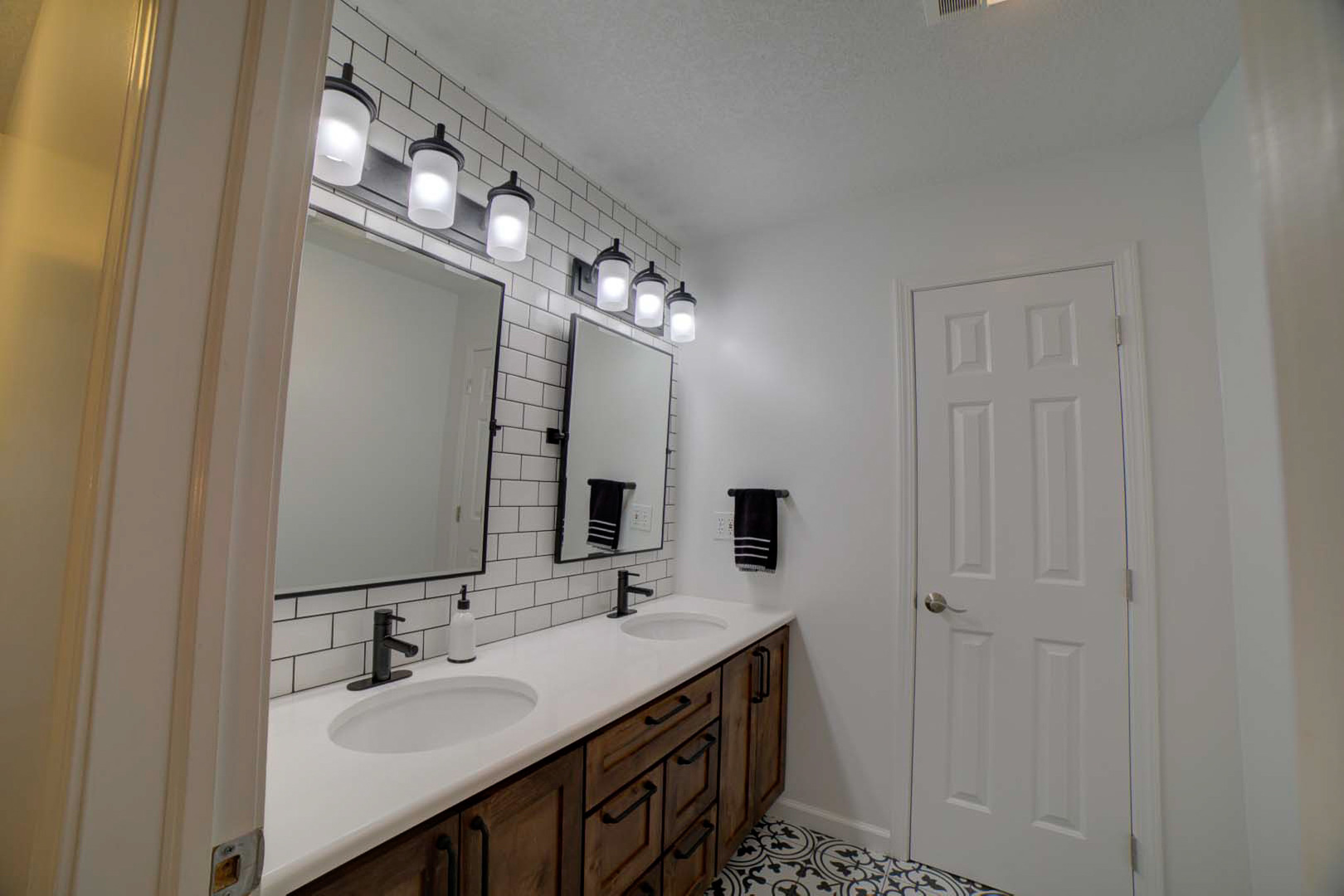 23 2130 East Watseka, IL 60970 - Photo 29 of 41 a bathroom with a double vanity sink and a mirror