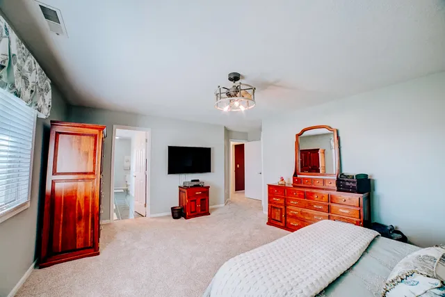 a view of a livingroom with furniture and a flat screen tv