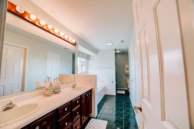 a view of a kitchen with stainless steel appliances granite countertop a stove and a refrigerator