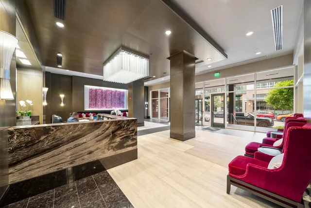 a living room with furniture a large window and a flat screen tv