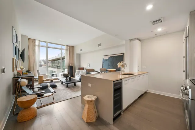 a view of kitchen with stainless steel appliances granite countertop sink stove and wooden floor