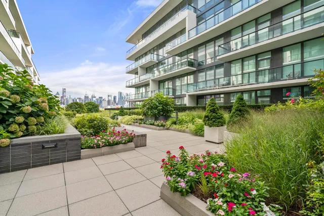 a balcony with furniture and a grill