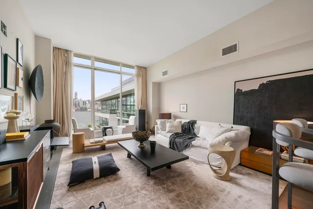 a living room with furniture a large window and a flat screen tv