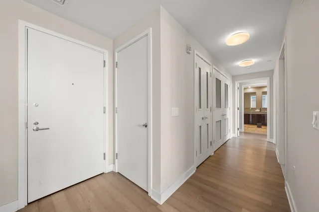 a view of a hallway with wooden floor