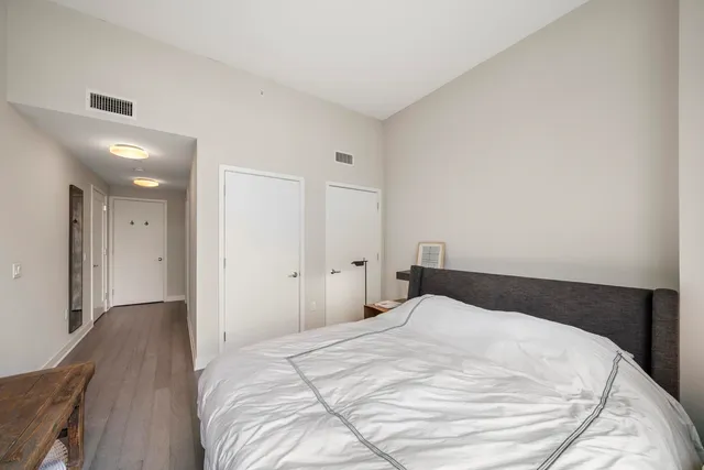 a bedroom with a bed and a night stand