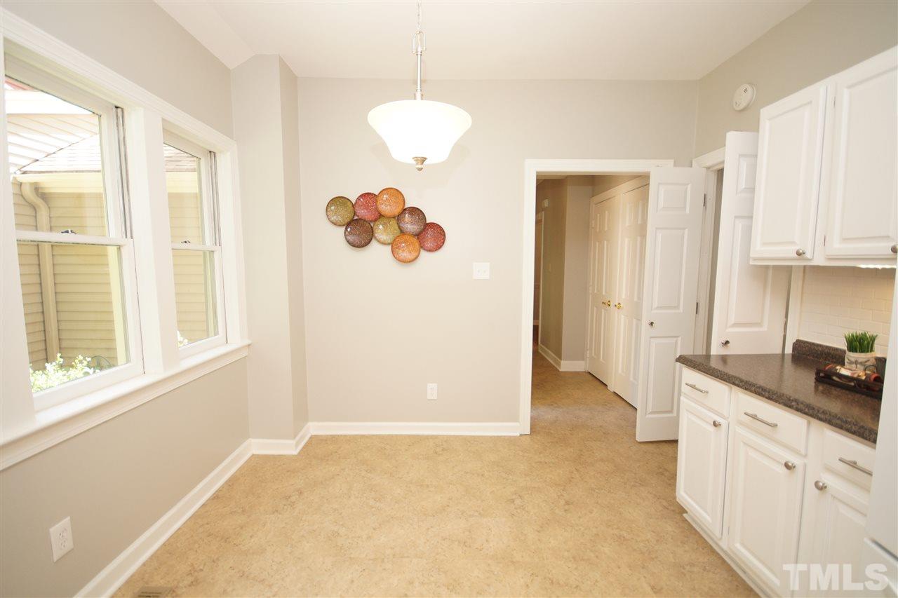 1729 Falls Church Road Raleigh, NC 27609 - Photo 12 of 25 a view of a kitchen with wooden cabinets and windows