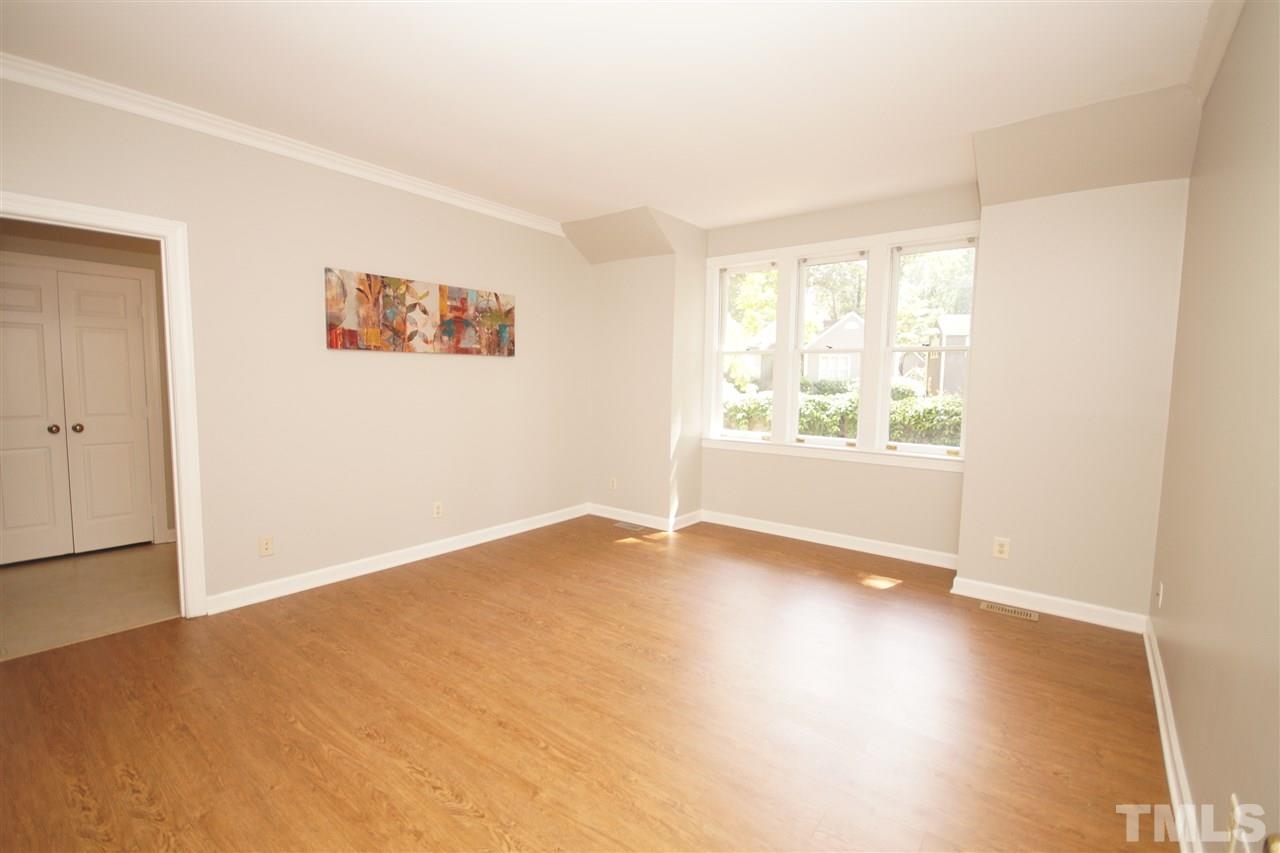 1729 Falls Church Road Raleigh, NC 27609 - Photo 13 of 25 an empty room with wooden floor and windows