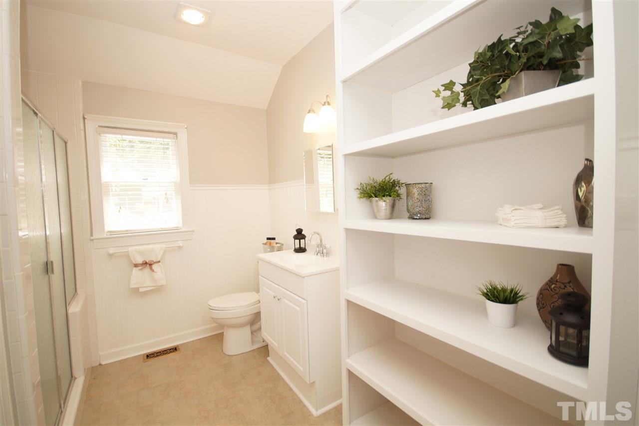 1729 Falls Church Road Raleigh, NC 27609 - Photo 15 of 25 a bathroom with a sink a toilet and a mirror