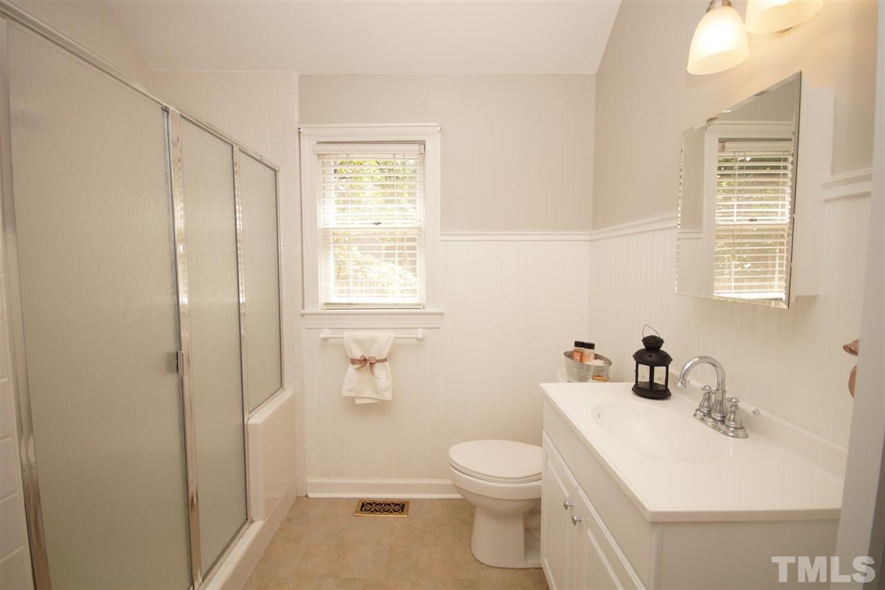 1729 Falls Church Road Raleigh, NC 27609 - Photo 16 of 25 a bathroom with a sink a toilet and a window