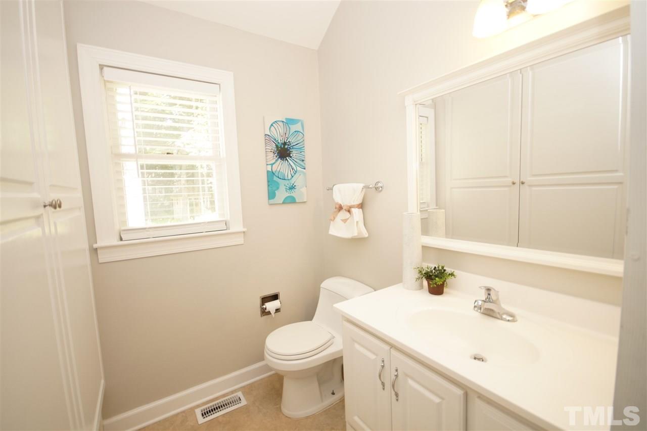 1729 Falls Church Road Raleigh, NC 27609 - Photo 19 of 25 a bathroom with a sink a toilet and window