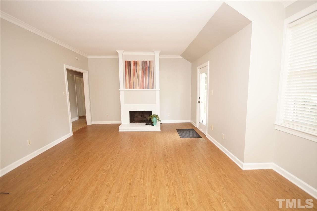 1729 Falls Church Road Raleigh, NC 27609 - Photo 3 of 25 a view of empty room with wooden floor and fan