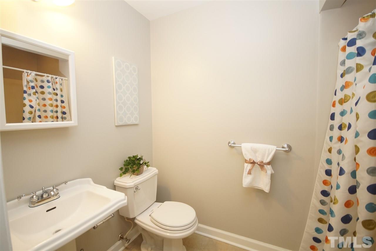 1729 Falls Church Road Raleigh, NC 27609 - Photo 23 of 25 a white toilet sitting next to a bathroom sink
