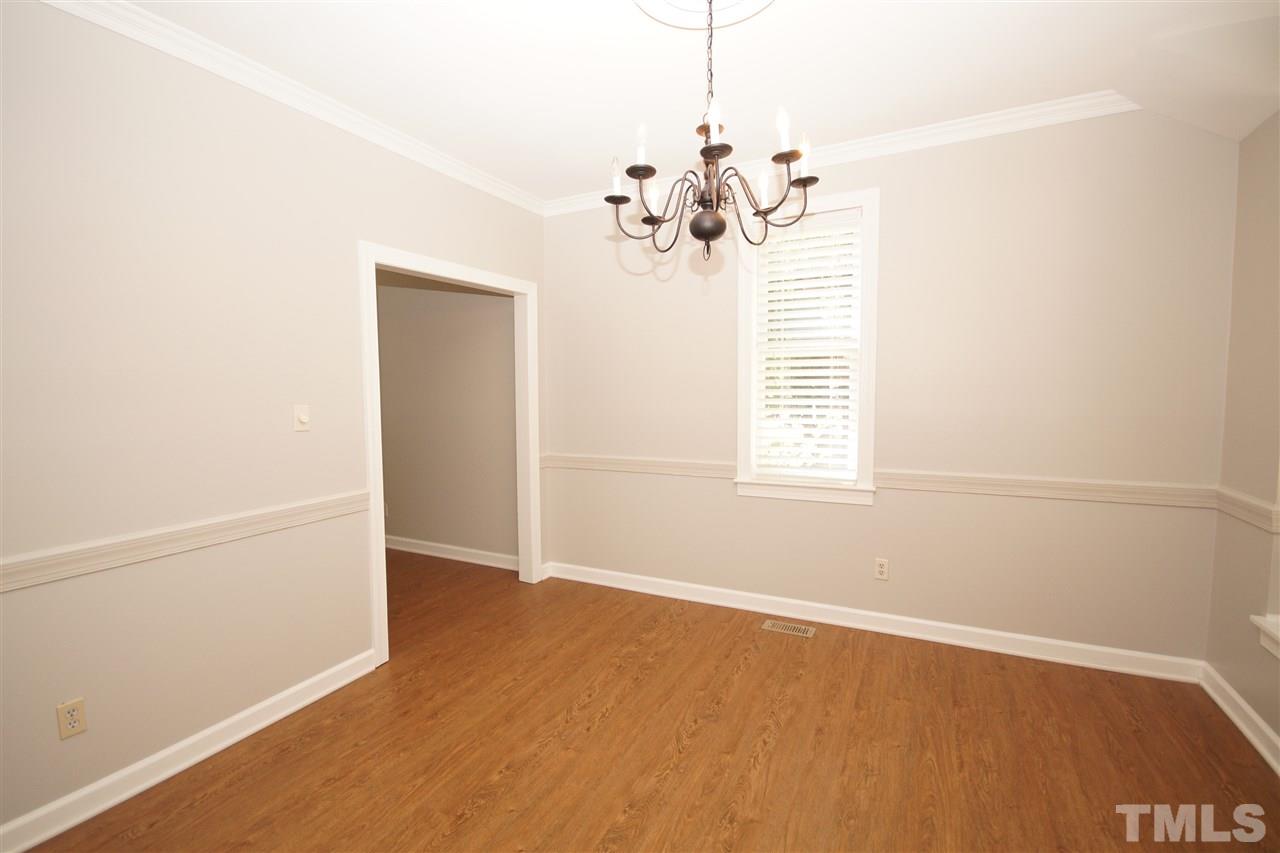 1729 Falls Church Road Raleigh, NC 27609 - Photo 7 of 25 an empty room with a window and wooden floor