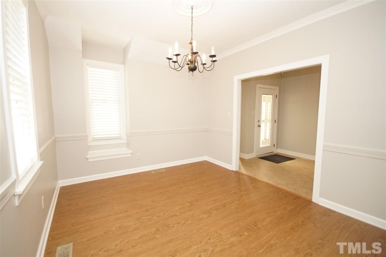 1729 Falls Church Road Raleigh, NC 27609 - Photo 8 of 25 a view of a livingroom with a chandelier fan
