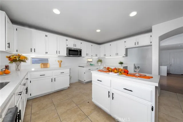 a kitchen with white cabinets and white appliances