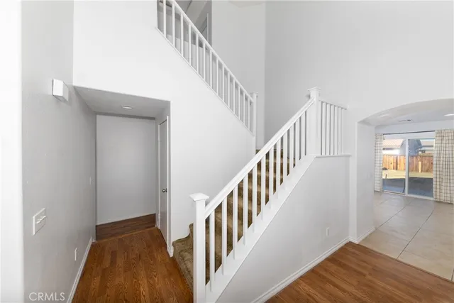 a view of staircase with wooden floor and a rug