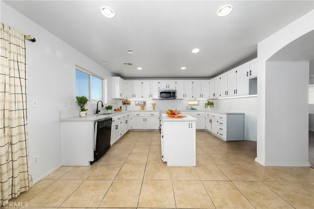 a kitchen with a sink a counter top space and cabinets