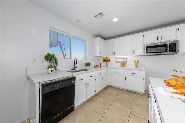 a kitchen with a sink stove and microwave