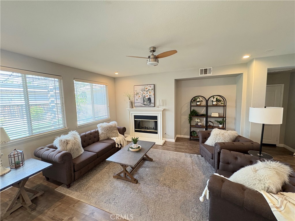 39707 Cambridge Place Temecula, CA 92591 - Photo 16 of 75 a living room with furniture window and a fireplace