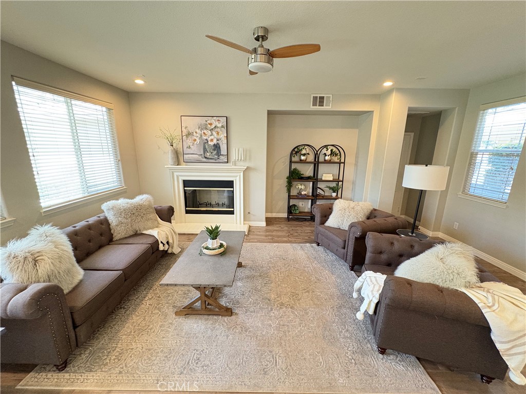 39707 Cambridge Place Temecula, CA 92591 - Photo 3 of 75 a living room with furniture fireplace and a large window