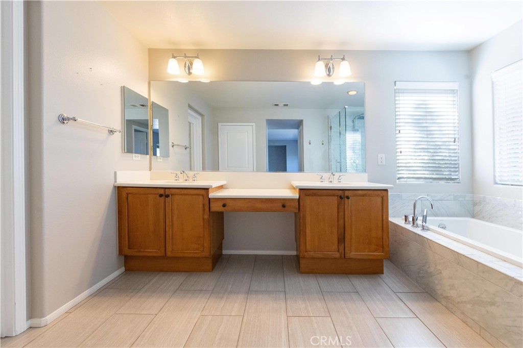 39707 Cambridge Place Temecula, CA 92591 - Photo 36 of 75 a bathroom with a sink double vanity mirror and a bathtub