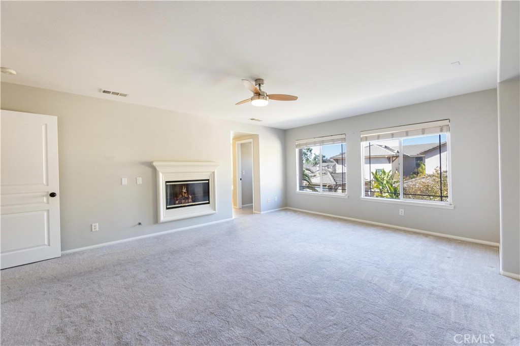39707 Cambridge Place Temecula, CA 92591 - Photo 60 of 75 an empty room with windows and ceiling fan