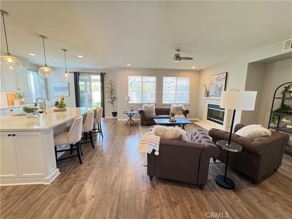 39707 Cambridge Place Temecula, CA 92591 - Photo 6 of 75 a living room with furniture a wooden floor and a large window