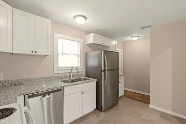 a kitchen with refrigerator and window