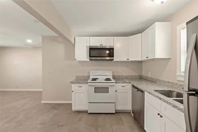 a kitchen with a stove top oven and cabinets