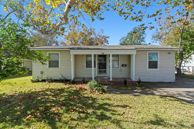 front view of a house with a yard
