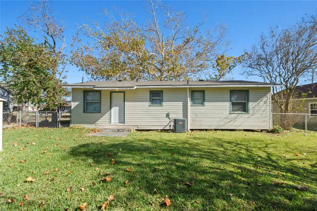 a house that has a tree in front of it