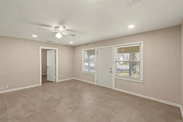 an empty room with windows and closet