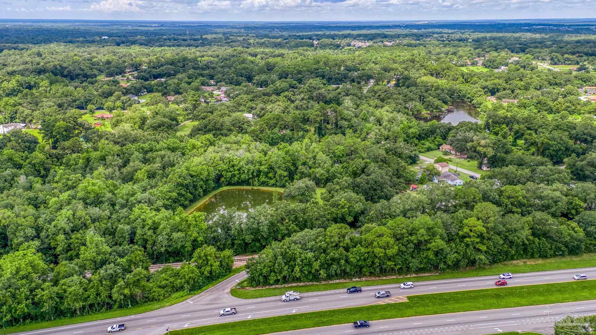 2345 Pompano Street Cantonment, FL 32533 - Photo 22 of 48 a view of a large yard with large trees
