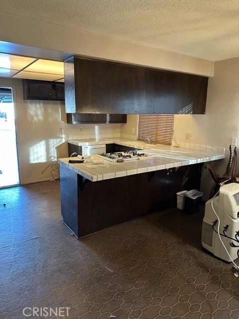 19309 Cliveden Avenue Carson, CA 90746 - Photo 2 of 4 a kitchen with a sink a stove and cabinets