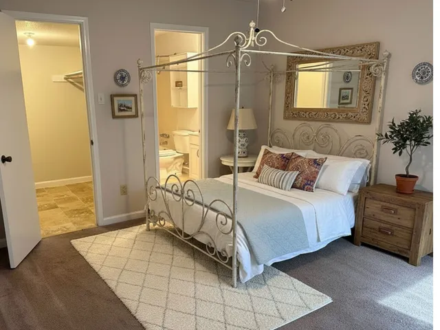 a spacious bedroom with a bed and a window