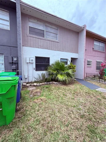 a backyard of a house with plants and outdoor seating