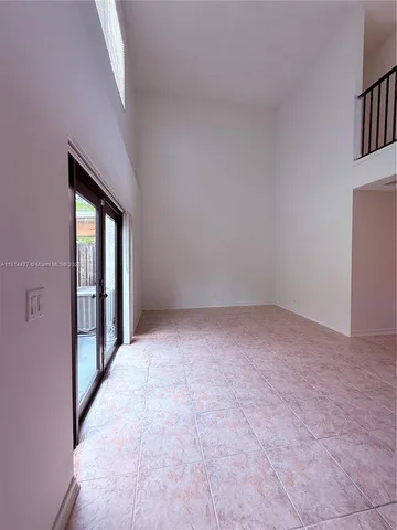 a view of a backyard with a patio and wooden fence