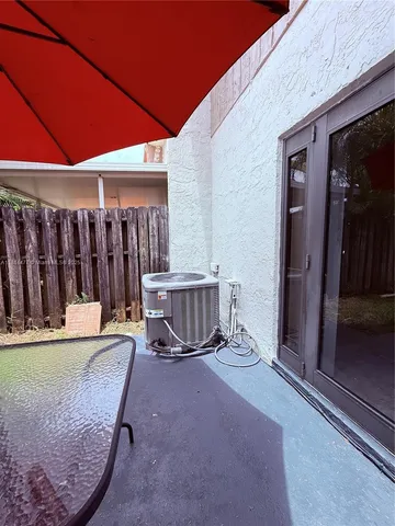 a view of backyard with seating space and wooden deck