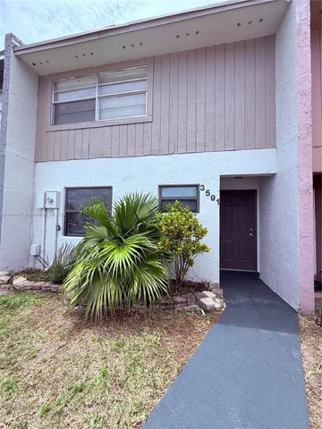 a potted plant in front of a door
