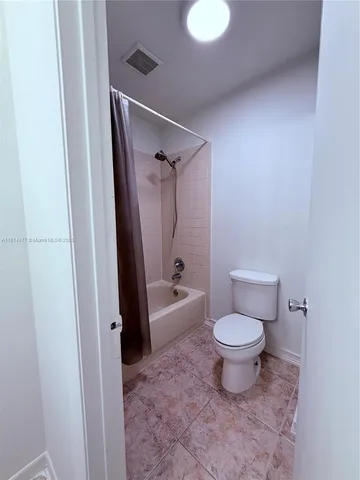 a view of a room with wooden floor and a window