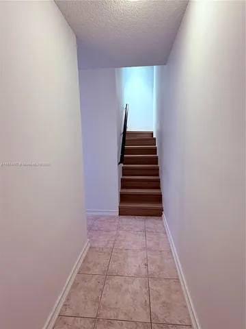 an empty room with mirror and vanity