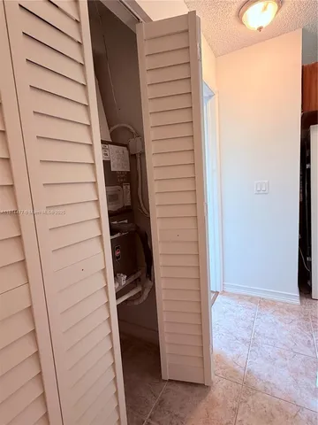 an empty room with wooden floor and a window