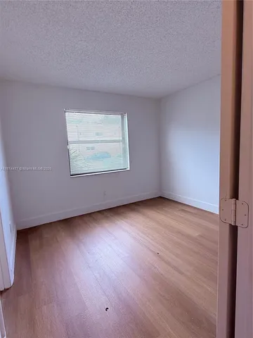 a bathroom with a granite countertop toilet sink and mirror