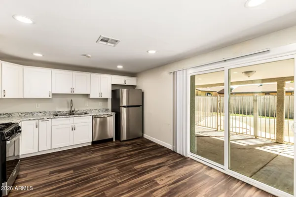 a kitchen with refrigerator cabinets and a sink