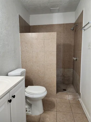 a bathroom with a toilet and a shower