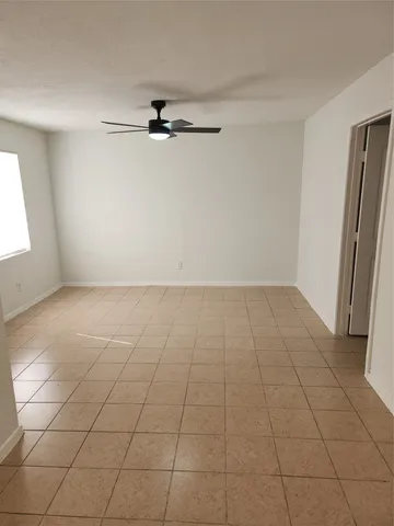 an empty room with a empty space and windows