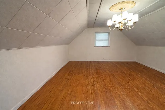 a view of a room with wooden floor and chandelier